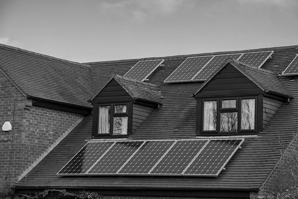 Old traditional English house roof with solar panels
