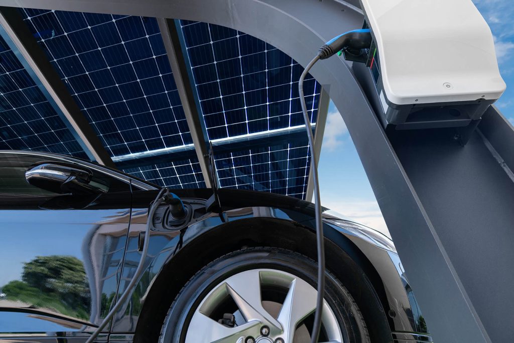 Electric car is charging in a car port that is powered by solar panels