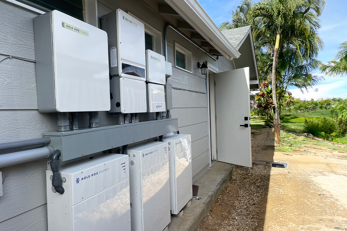 Solar battery bank installed on side of single-family home