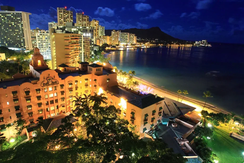 Nighttime beaches and hotels in Waikiki, Oahu. Diamond head is visible in the background.