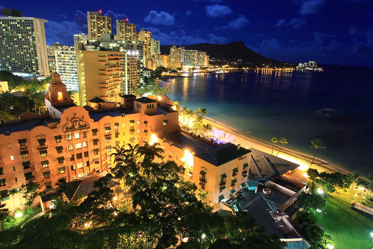 Nighttime beaches and hotels in Waikiki, Oahu. Diamond head is visible in the background.